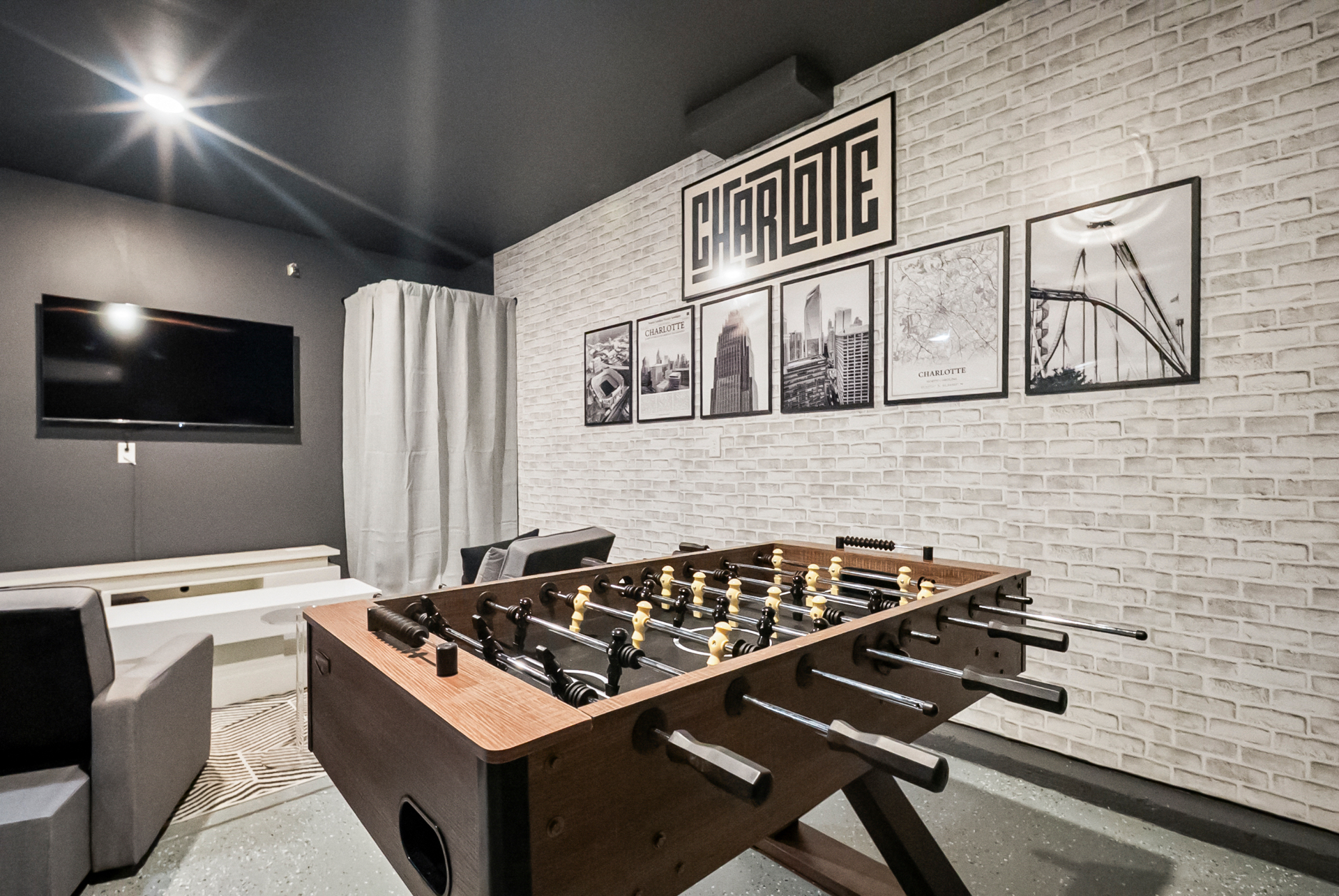 Game room with foosball and Charlotte-themed decor
